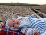 Jacob sunbathing on Seaford beach - click to enlarge